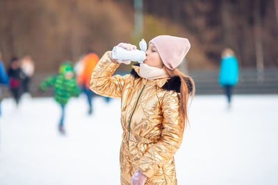 Midsection of woman photographing with umbrella