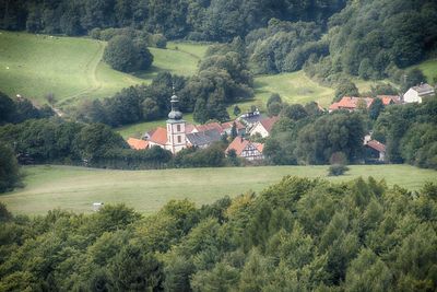 Scenic view of agricultural field by houses