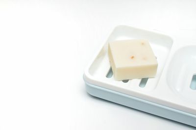 High angle view of bread in plate against white background