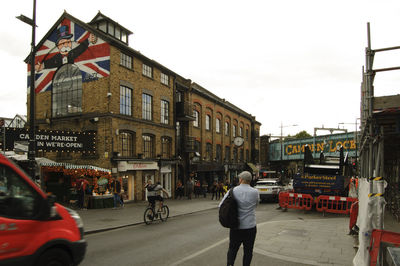 People on city street against sky