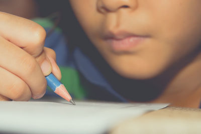 Close-up of baby hand holding paper