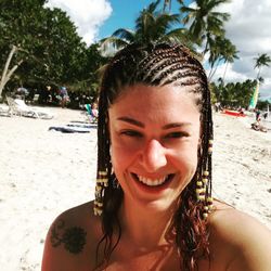 Portrait of smiling young woman at beach