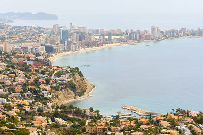 Aerial view of buildings by sea