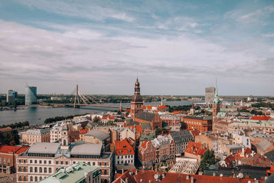 High angle view of buildings against cloudy sky