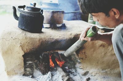 Cropped image of man blowing chulah