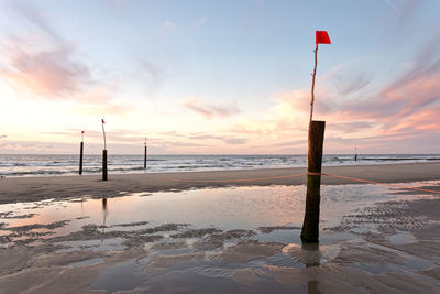 Scenic view of beach against sky during sunset