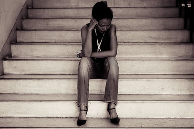 Tensed woman sitting on steps