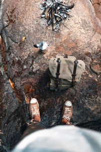 Low section of man standing on rock