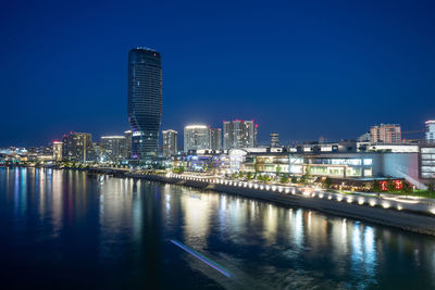 Illuminated city at waterfront