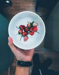 Midsection of person holding strawberry