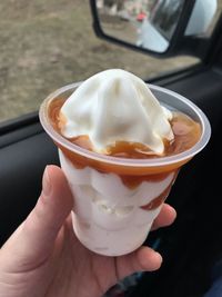 Midsection of person holding ice cream in glass