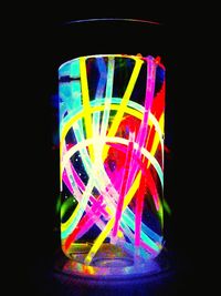 Close-up of colorful light painting against black background