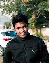 Portrait of young man standing outdoors