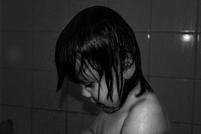 Close-up of shirtless boy in bathroom