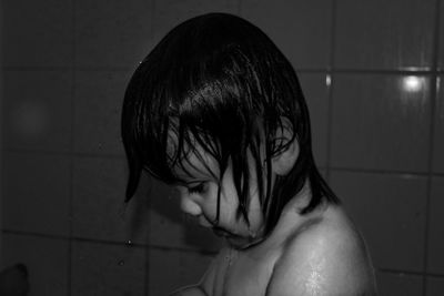 Cute shirtless boy bathing in bathroom