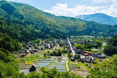 High angle view of trees and buildings against sky