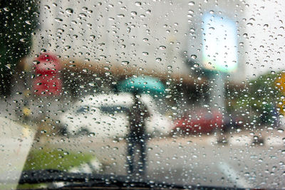 Raindrops on glass window of rainy season