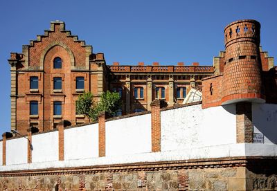 Low angle view of historic building against clear blue sky