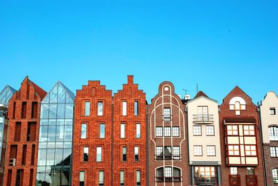 Low angle view of buildings against blue sky