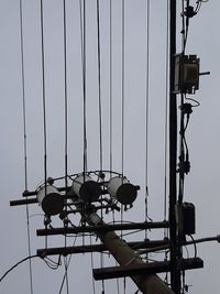 Low angle view of chain swing ride against sky