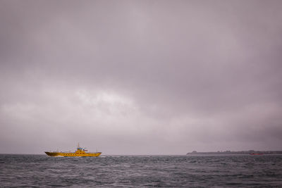 Boat sailing in sea against sky