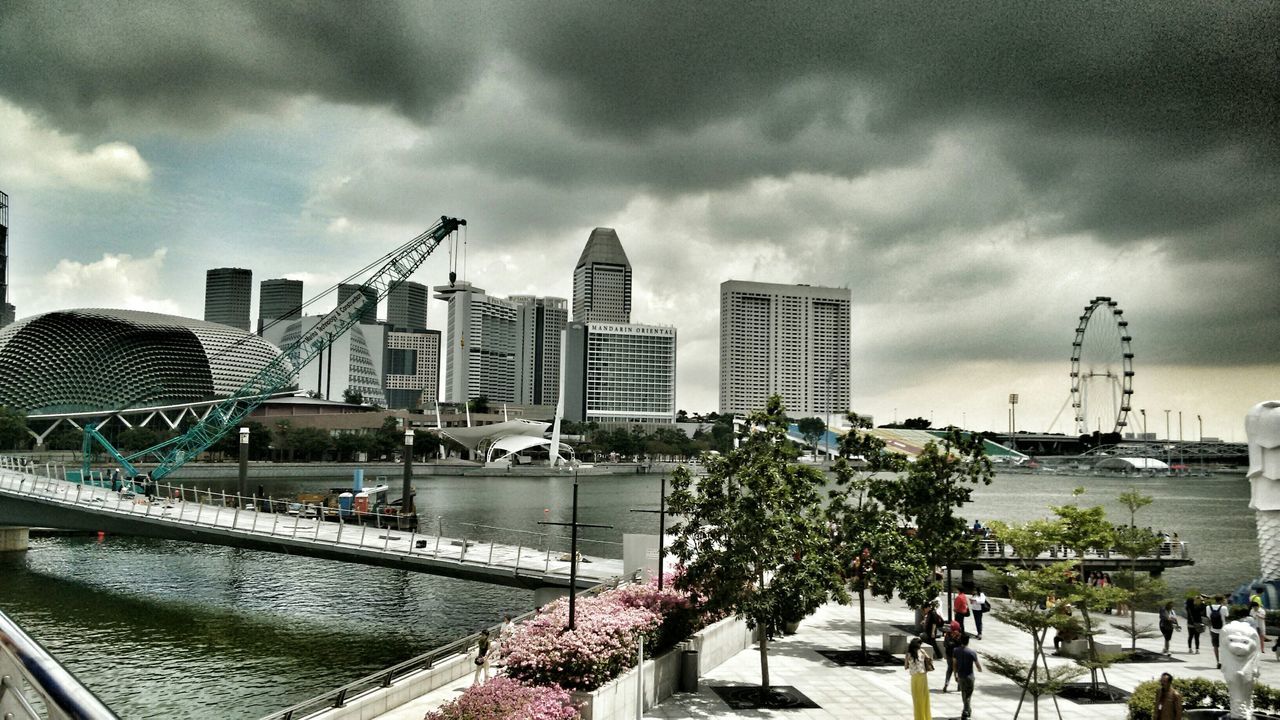 building exterior, architecture, built structure, sky, cloud - sky, city, cloudy, cityscape, modern, overcast, cloud, transportation, skyscraper, city life, weather, crane - construction machinery, development, incidental people, building, day