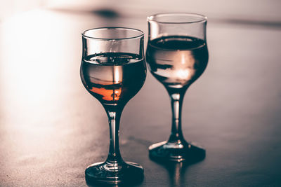 Close-up of wine glasses on table