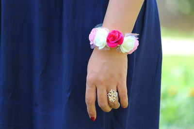 Close-up of woman holding pink flower