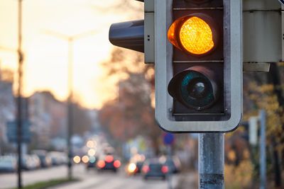 Stoplight in city during sunset