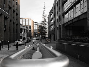 Cars on street amidst buildings in city