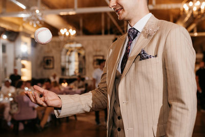 Midsection of man holding in suit asking for dance