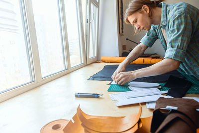 Woman working on table at home