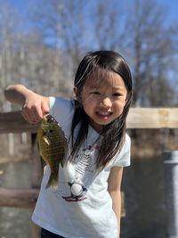 Portrait of a girl holding bird