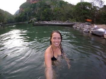 Portrait of smiling young woman in river