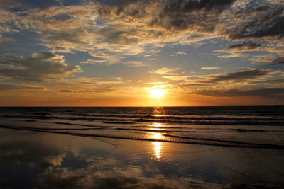 View of calm beach at sunset