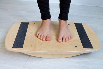 Low section of woman standing on table