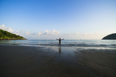 Scenic view of beach against blue sky