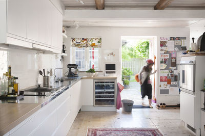 View of kitchen, person entering through patio door