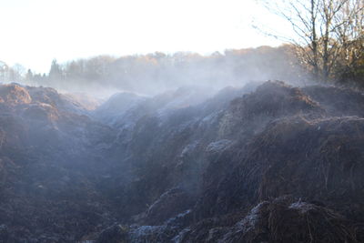 Steam rising off dung heap on a cold morning 