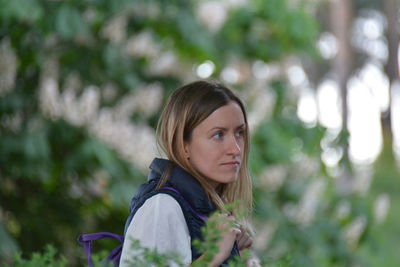 Portrait of young woman looking away outdoors