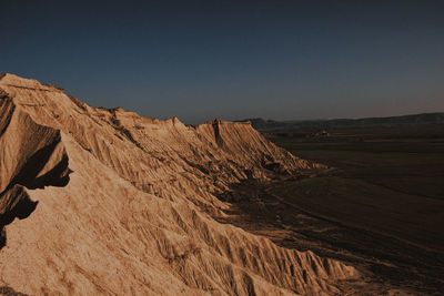 Scenic view of mountains and landscape against clear sky