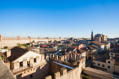 High angle view of buildings against clear blue sky