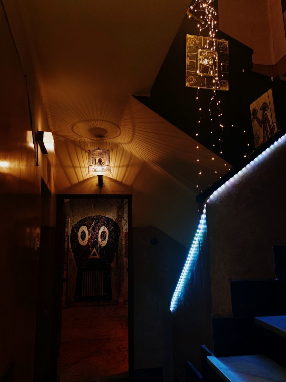 ILLUMINATED CHANDELIER HANGING FROM CEILING