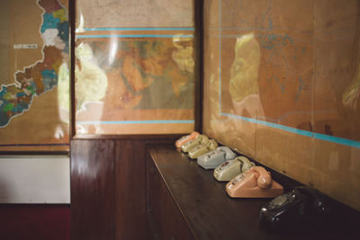 Telephones arranged by wall on table