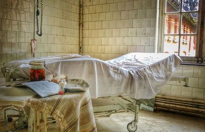 Bed and table at abandoned hospital