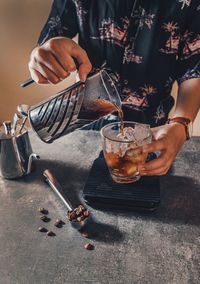 Man holding ice cream on table