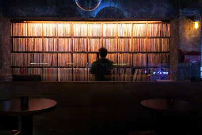 Rear view of man playing piano