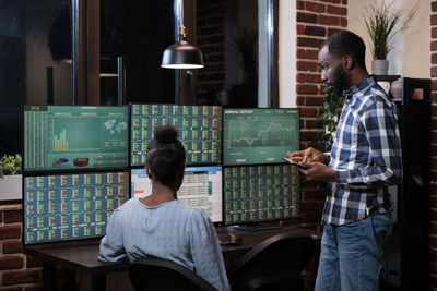 Business colleagues analyzing graph on computer