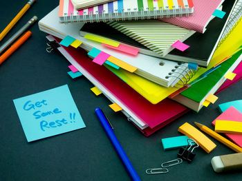 High angle view of text on paper with books at desk