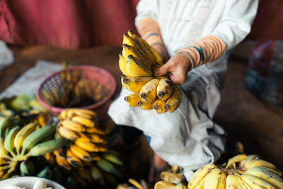 Midsection of man picking fruit